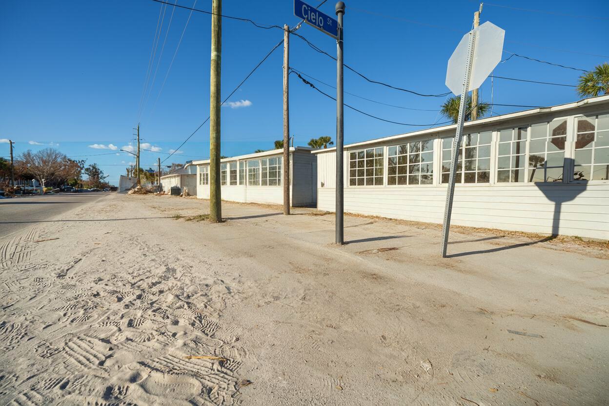 After: the same sidewalk swept clean, with the sand, poles and building clear
